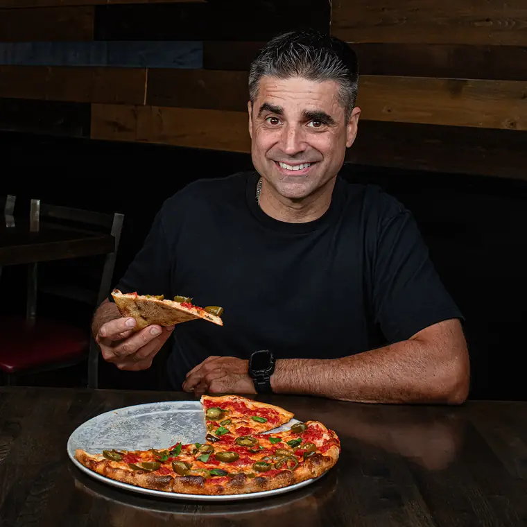 The owner with a fresh pie at Wayne Ale House